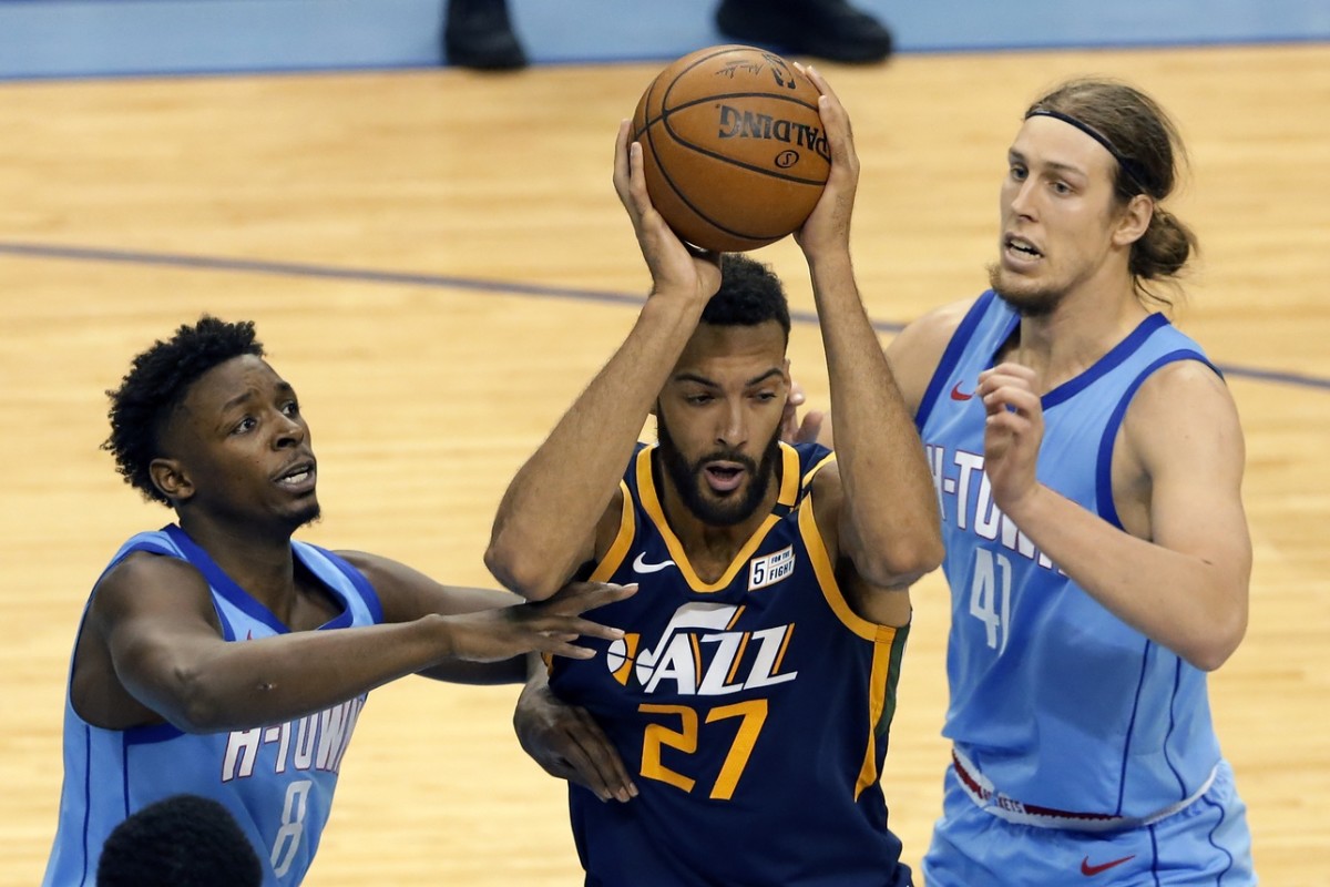 Rudy Gobert (27) fights through a crowd of defenders against the Houston Rockets